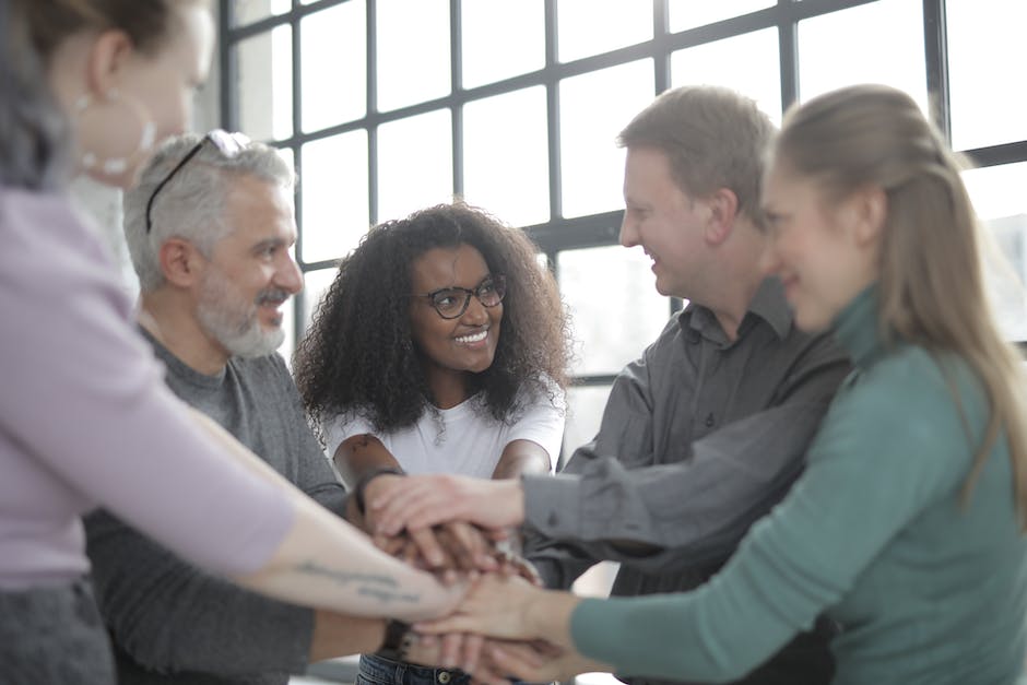 An image showing a diverse group of people supporting each other, symbolizing the importance of addressing disproportionate impacts and risk factors of mental health disorders.