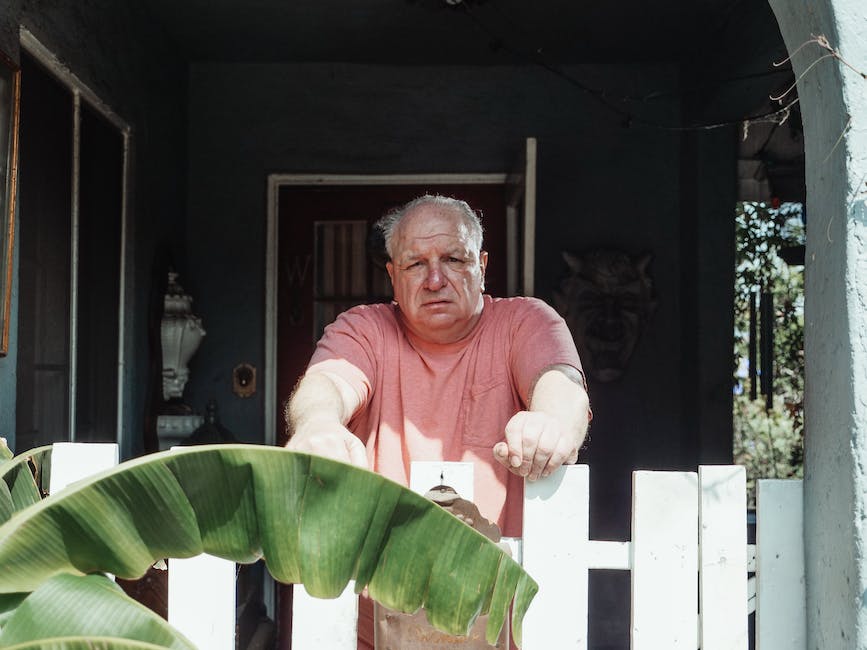 Image depicting a man sitting alone with a sad expression, representing male depression.