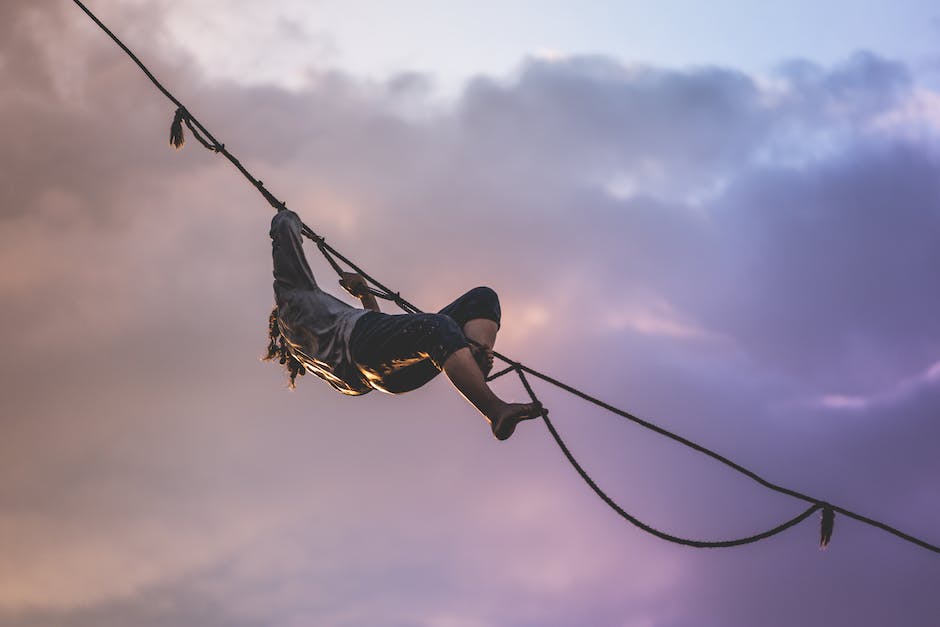 An image illustrating the concept of mental and emotional well-being, showing a person balancing on a tightrope between two pillars representing mental and emotional stability.