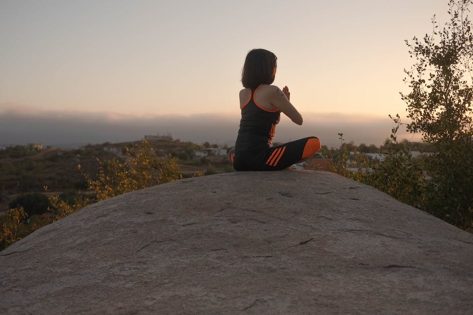 Image depicting a person meditating with a serene background