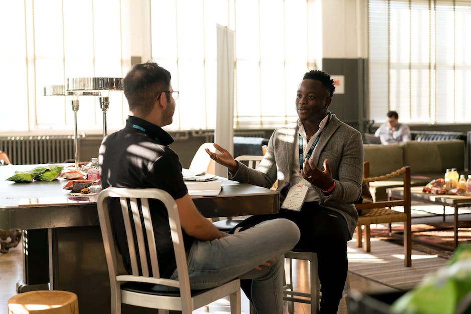 A diverse group of men supporting each other and having a conversation about mental health