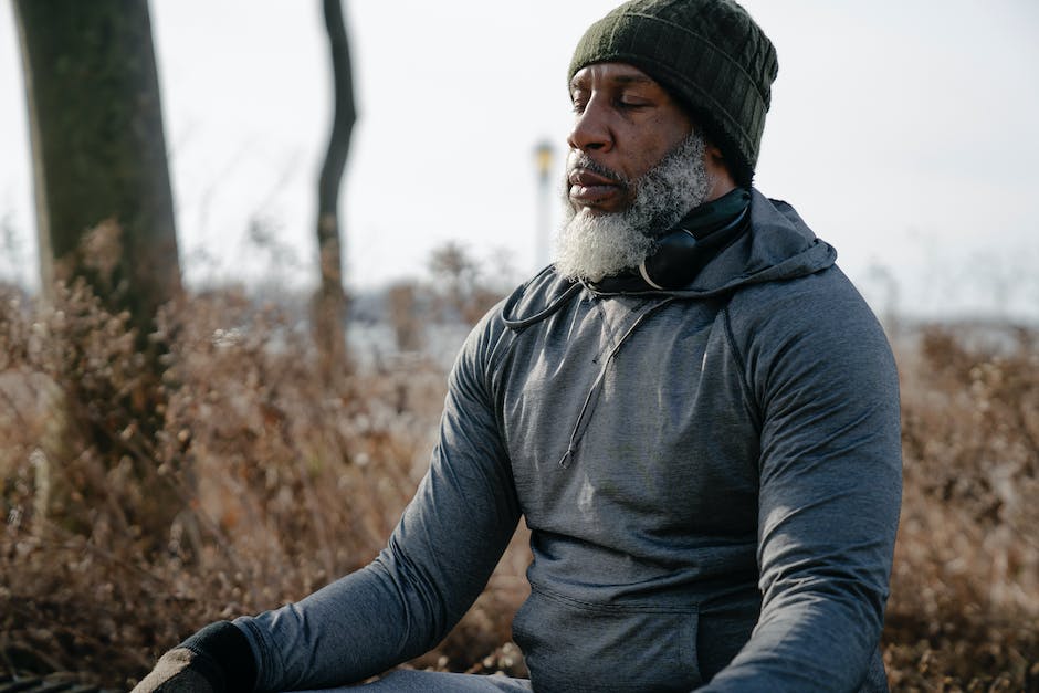 Conceptual image of a man sitting cross-legged in a peaceful, natural setting with serene surroundings.